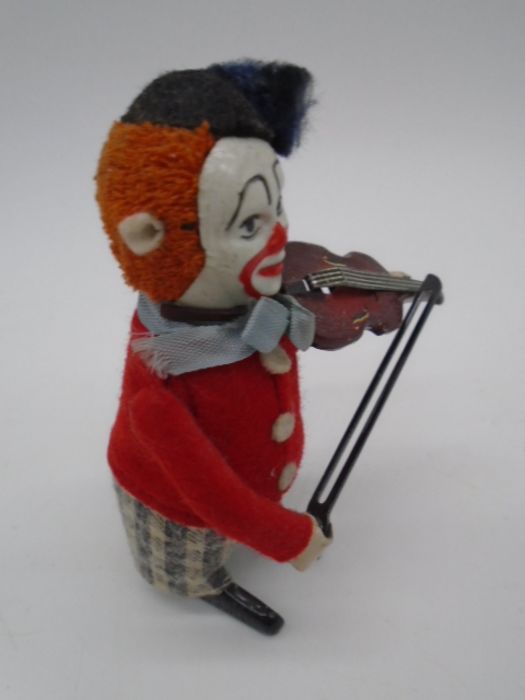 Three vintage Schuco clockwork tinplate toys in the form of clowns playing the violin (one with an - Image 9 of 11