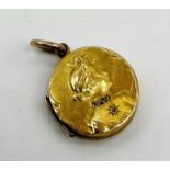 A small 15ct gold locket embossed with a portrait bust of a lady with diamond collar- 1 stone
