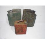 A vintage petrol can, along with two jerry cans