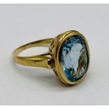 A 9ct gold ring set with vibrant blue topaz