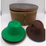 A vintage bent wood hat box with five hats enclosed