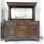 An oak mirror backed sideboard with fluted columns - length 152cm, height 179cm, depth 34cm.