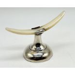 A vintage silver knife rest