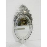 A large Venetian style oval wall mirror - height 142cm, length 65cm