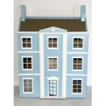 A vintage doll's house styled on a three story Georgian townhouse with a quantity of furniture etc,
