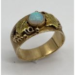 A 14ct gold ring set with a cabochon opal, total weight 7.7g