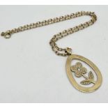 A 9ct gold flower pendant set with a diamond on 9ct gold chain, total weight 14.7g