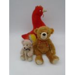 A Steiff "Happy Teddy" plush bear with light brown fur, along with a small limited edition Beau