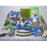 A collection of various model railway accessories and scenery including buildings, trees, signals,