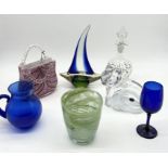 A collection of glassware including Laguna handbag, decanter, blue glass jug, Bohemia cat etc.