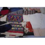 A large assortment of vintage fabrics, clothes, bags etc