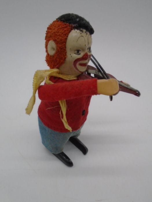Three vintage Schuco clockwork tinplate toys in the form of clowns playing the violin (one with an - Image 3 of 11