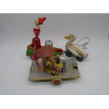 Two vintage wooden pull-along toys including a Chad Valley duck, along with a tinplate pull-along