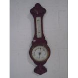 A carved oak banjo barometer