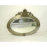 A hammered metal framed oval wall mirror