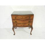 A burr-walnut veneer chest of three drawers with serpentine front, raised on cabriole legs -