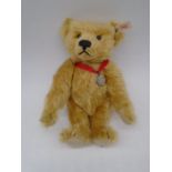 A Steiff teddy bear (No.654725) with golden blonde mohair fur and Christie's silver pendant,