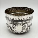 A hallmarked silver bowl with repousse decoration, weight 62.5g