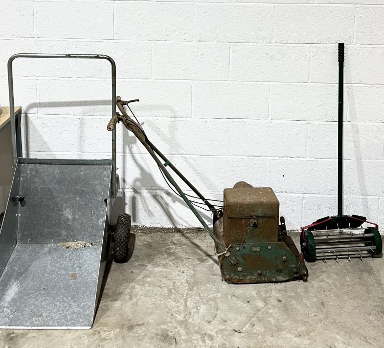 A Webb vintage lawnmower along with a galvanised wheelbarrow and a spiked aerator