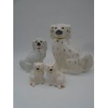 A collection of four ceramic Staffordshire dogs, including two by Royal Doulton