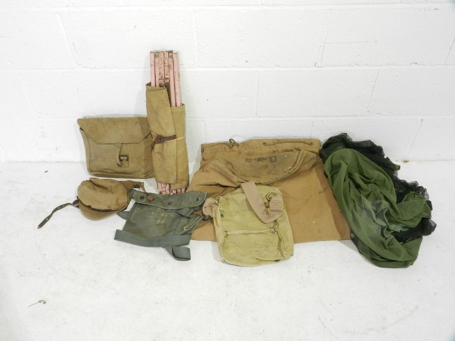 A collection of WW2 era military canvas bags, bed, hat etc. Some with broad arrow mark.