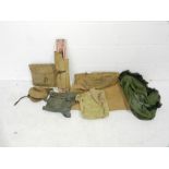 A collection of WW2 era military canvas bags, bed, hat etc. Some with broad arrow mark.