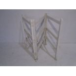 A vintage white painted clothes rail
