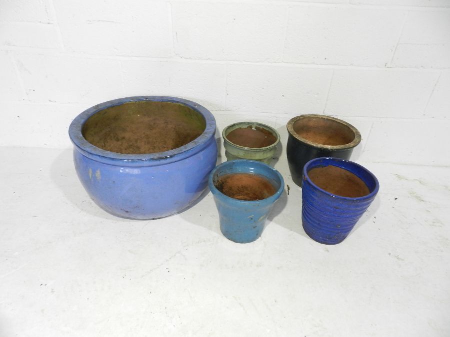 A large blue glazed garden pot along with four smaller pots