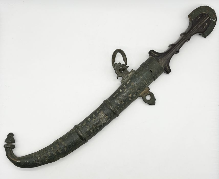 An antique Eastern Jambiya knife and scabbard with shaped wooden handle