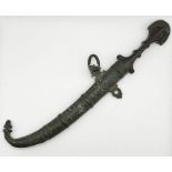 An antique Eastern Jambiya knife and scabbard with shaped wooden handle