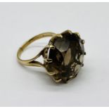 A 9ct gold ring set with a large smoky quartz