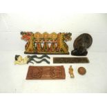 A small collection of Eastern carvings including a tribal bust, carved gourd etc.