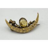 A 9ct gold crescent shaped brooch set with a citrine, total weight 2.8g