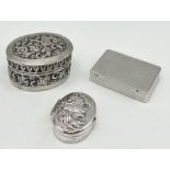 A continental 830 silver pill box along with an Indian silver oval box and one other