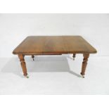 A Victorian mahogany wind-out table on fluted legs with one leaf (no winder) - 149cm x 104cm.