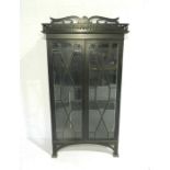 A turn of the century ebonised oak glazed display cabinet with fretwork decoration - length 101cm,