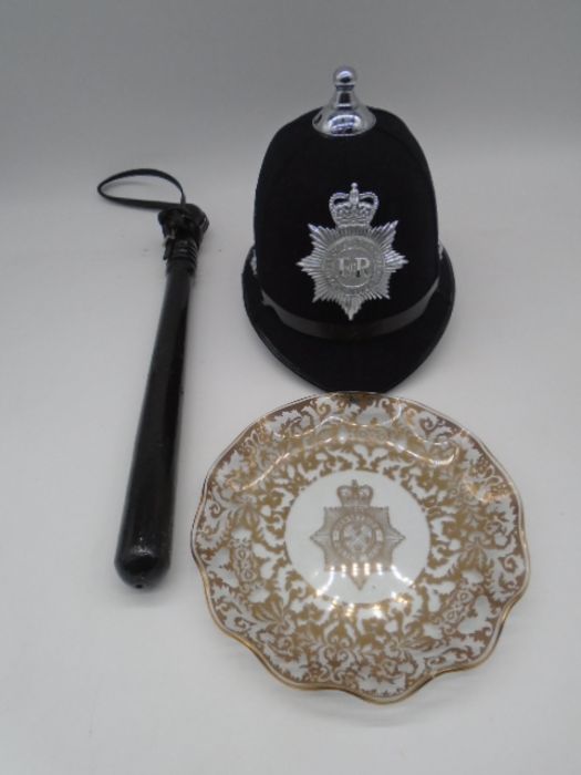 A vintage Devon & Cornwall Constabulary police officers helmet, along with a truncheon and