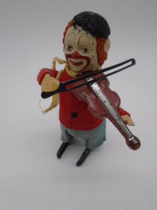 Three vintage Schuco clockwork tinplate toys in the form of clowns playing the violin (one with an - Image 2 of 11