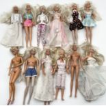 A collection of vintage Barbie dolls in various outfits including wedding dress etc.