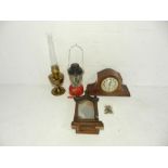 A Tilley lamp along with two mantel clocks (A/F) etc.