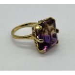 A 9ct gold ring set with a large colour changing stone