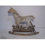 An antique child's wooden rocking horse