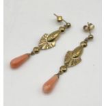 A pair of 9ct gold earrings with coral drops