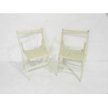 A pair of painted wooden folding garden chairs