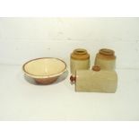 A glazed terracotta creamer along with two stoneware pots and a hot water bottle