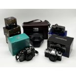 A collection of Olympus cameras, lenses etc including OM10 and OM40 in original boxes with manual,