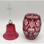 A Bohemian cranberry glass vase along with large cranberry glass bell