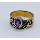 A 9ct gold Celtic influenced ring set with an amethyst, weight 4.8g