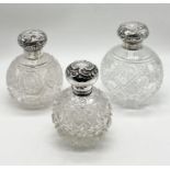 Three silver topped cut glass scent bottles