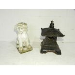 A reconstituted stone Fo dog garden ornament along with a black pagoda